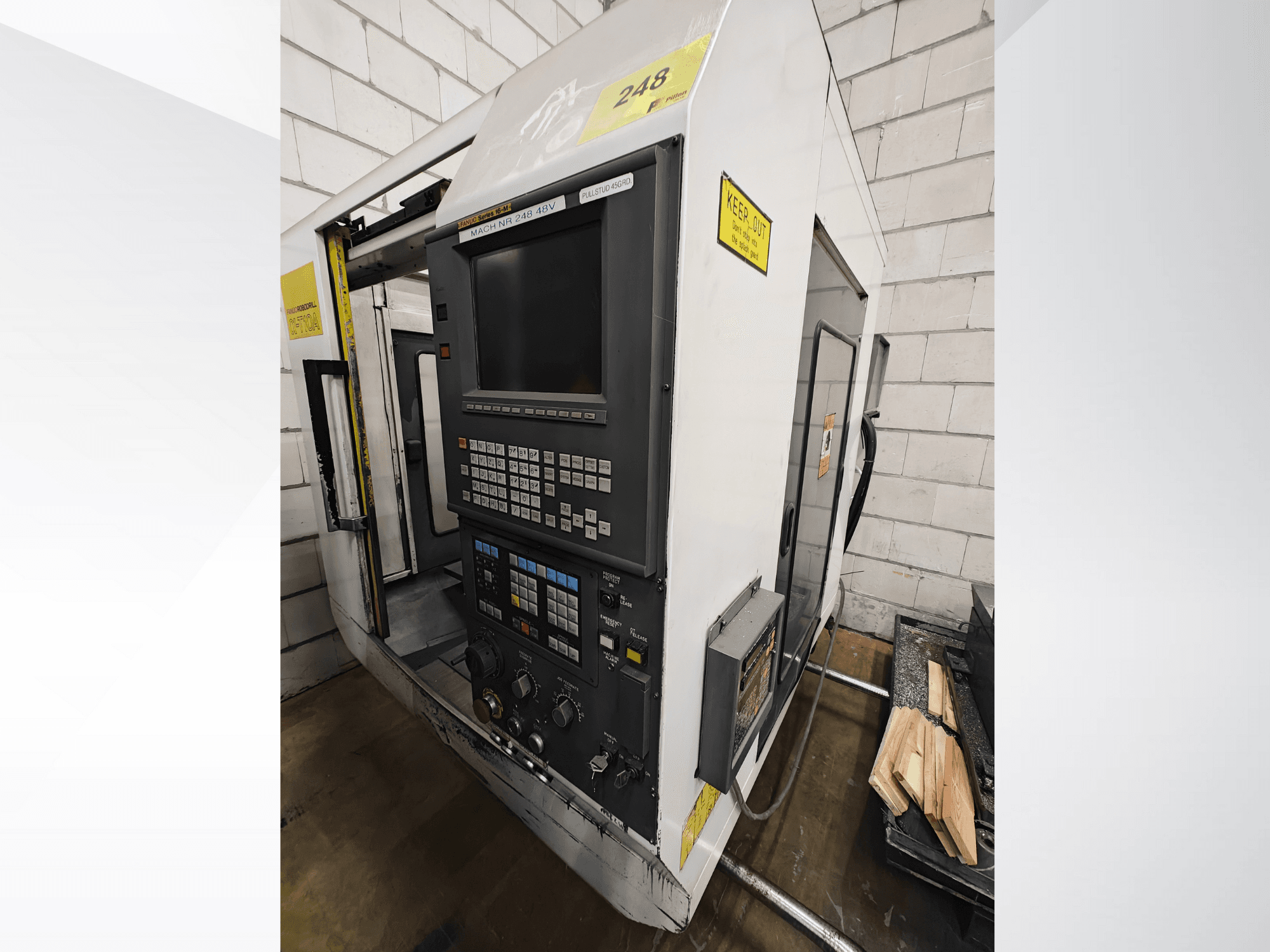 CNC machine model Nr 248, front view, featuring a control panel with buttons and display, with wood pieces on a shelf nearby.